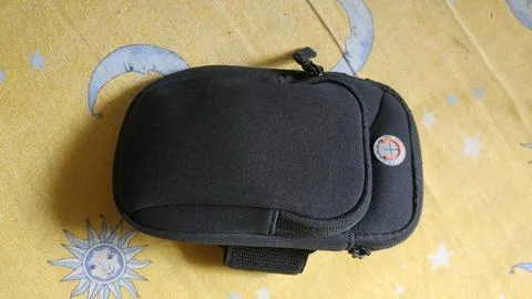 Black Compact Camera Pouch on a Patterned Background Foto stock