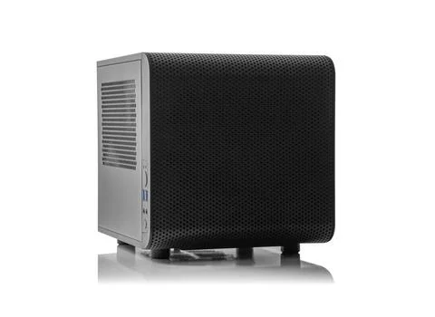 A black, compact mini-ITX computer case isolated on a white background with a Stock Photos