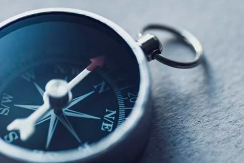 Black compass close-up shows the direction to move. Stock Photos