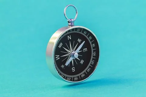 Black compass floating on the blue background Stock Photos