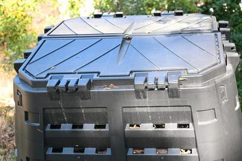 Black compost bin in a garden Stock Photos