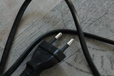 Black computer cable lying on a gray floor 写真素材