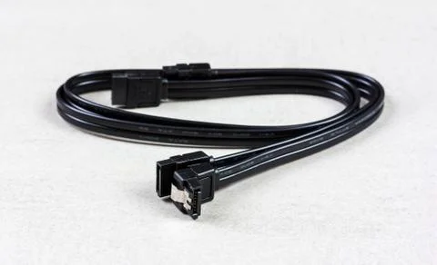 Black computer cable Serial ATA 6Gbs  on grey background closeup Stock Photos