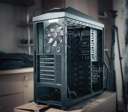 A black computer case without side walls on a blurred background. disassemble Stock Photos