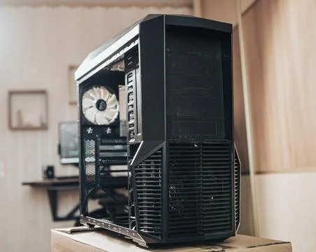 A black computer case without side walls in a living room with a blurred back Stock Photos