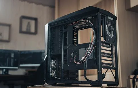 A black computer case without side walls in a living room with a blurred back Stock Photos