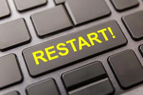 Black computer key with "restart!" in yellow capital letters.  Stock Photos