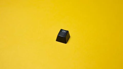 Black computer keyboard isolated on yellow background. Copy space for text. Stock Photos
