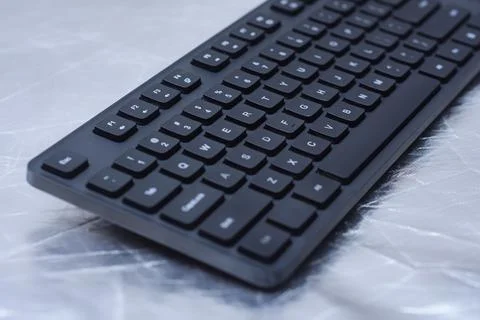 Black computer keyboard with keys on a desk surface. Modern workspace, offi.. Stock Photos