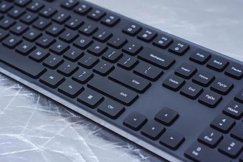 Black computer keyboard with keys on a desk surface. Modern workspace, offi.. Stock Photos