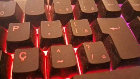 Black computer keyboard keys glowing with intense bright red light Stock Photos