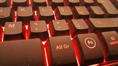 Black computer keyboard keys glowing with intense bright red light Stock Photos