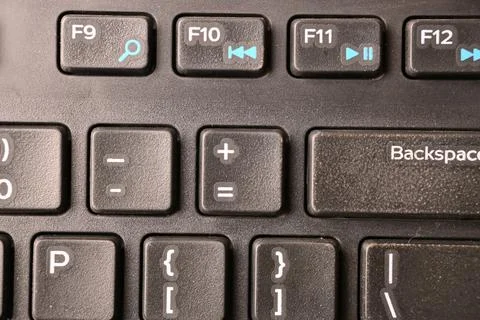 Black Computer Keyboard Macro Shot Highlighting Plus Equals Key with Soft B.. Stock-Fotos
