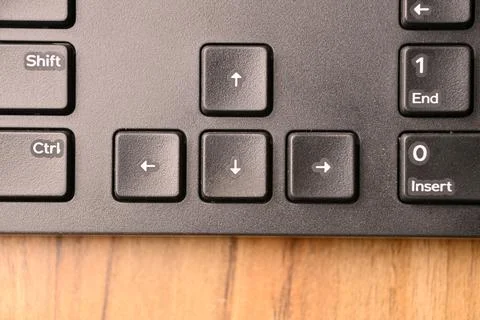 Black Computer Keyboard Macro Shot Highlighting Down Arrow Key with Soft Bl.. Stock Photos