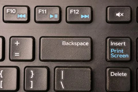 Black Computer Keyboard Macro Shot Highlighting Backspace Key with Soft Blu.. Stock Photos