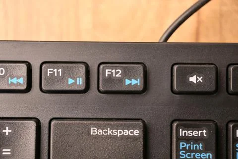 Black Computer Keyboard Macro Shot Highlighting F12 Key with Soft Blurred B.. Stock Photos