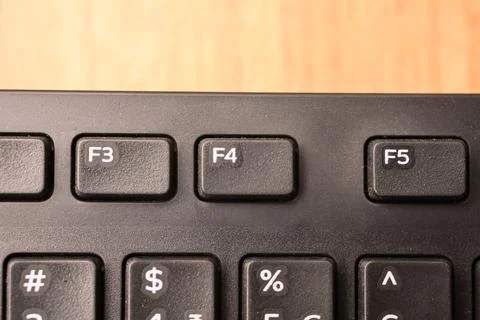 Black Computer Keyboard Macro Shot Highlighting F4 Key with Soft Blurred Ba.. Stock-Fotos
