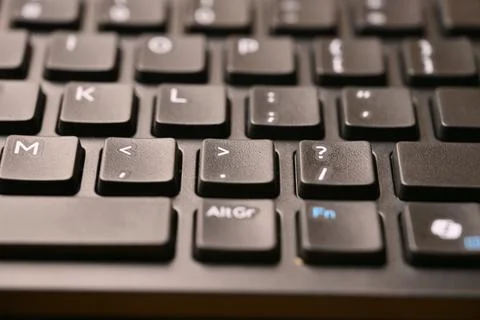 Black Computer Keyboard Macro Shot Highlighting Period and Greater Than Key.. Stock Photos