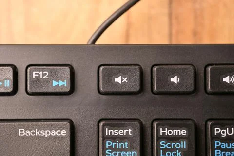 Black Computer Keyboard Macro Shot Highlighting Mute Volume Key with Soft B.. Foto stock