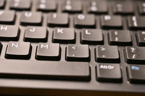 Black Computer Keyboard Macro Shot Highlighting Comma and Less Than Key wit.. Stock Photos