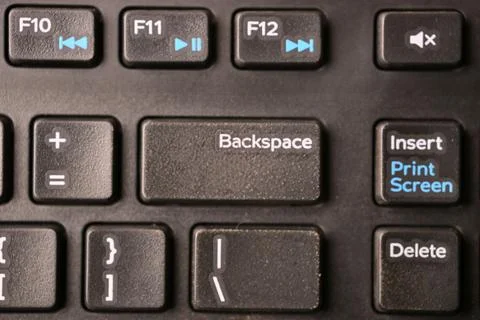 Black Computer Keyboard Macro Shot Highlighting Backspace Key with Soft Blu.. Foto stock