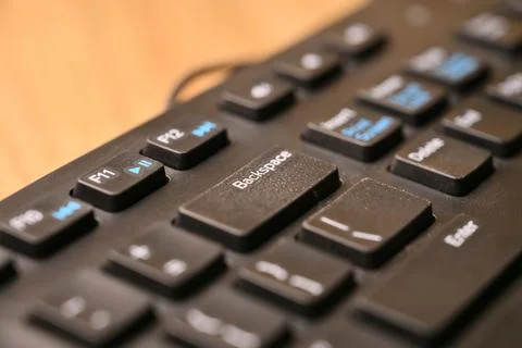 Black Computer Keyboard Macro Shot Highlighting Backspace Key with Soft Blu.. 스톡 사진