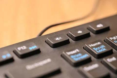 Black Computer Keyboard Macro Shot Highlighting Mute Sound Key with Soft Bl.. Stock Photos