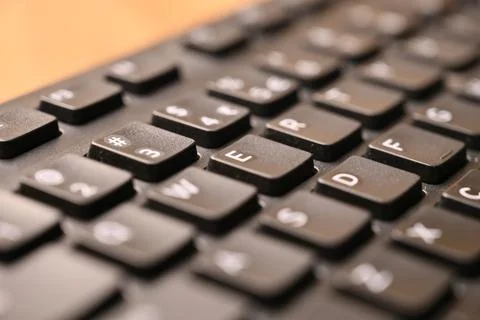 Black Computer Keyboard Macro Shot Highlighting E Key with Soft Blurred Bac.. Stock Photos