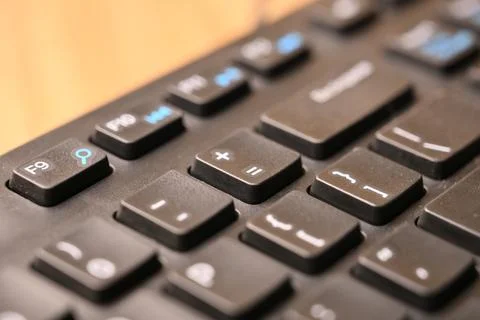 Black Computer Keyboard Macro Shot Highlighting Equals and Plus Key with So.. Foto stock