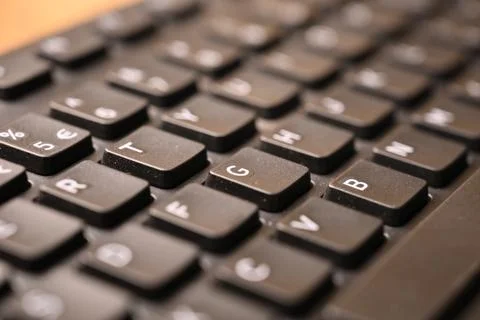 Black Computer Keyboard Macro Shot Highlighting G Key with Soft Blurred Bac.. Foto stock