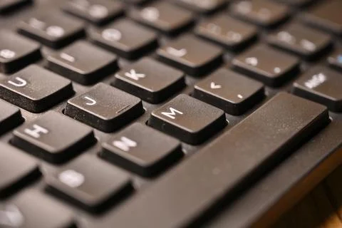Black Computer Keyboard Macro Shot Highlighting M Key with Soft Blurred Bac.. Stock Photos