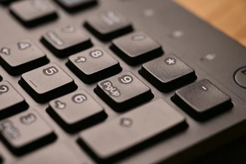 Black Computer Keyboard Macro Shot Highlighting Num Lock Area and 9 Key on .. Foto stock