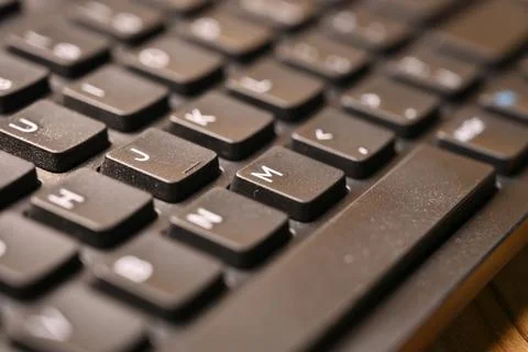 Black Computer Keyboard Macro Shot Highlighting M Key with Soft Blurred Bac.. Stock Photos
