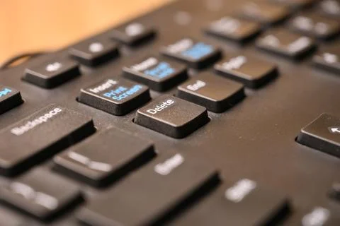 Black Computer Keyboard Macro Shot Highlighting Delete Key with Soft Blurre.. Stock Photos