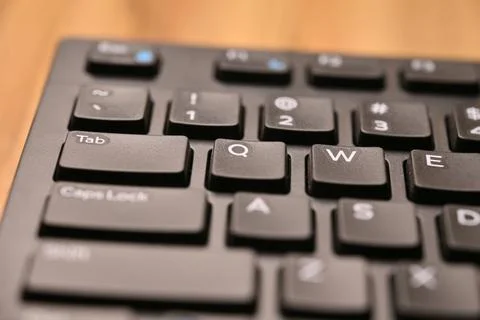 Black Computer Keyboard Macro Shot Highlighting Q Key with Angled Top View .. Foto stock