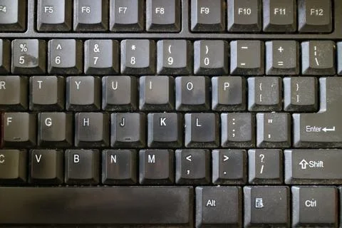 A black computer keyboard, slightly dusty Stock Photos