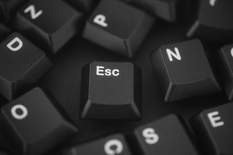 Black computer keys scattered on a black background. Stock Photos