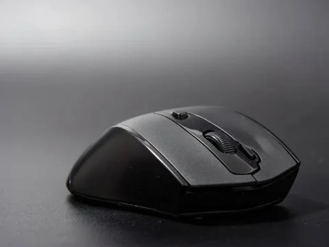 Black computer mouse on dark surface for office work 写真素材
