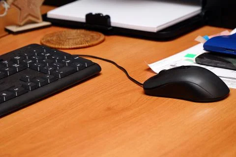 Black computer mouse on the desktop in office Stock Photos