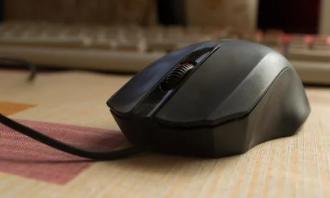 Black computer mouse on the desktop. Stock Photos