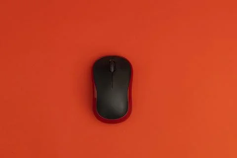 Black computer mouse on red background Stock Photos