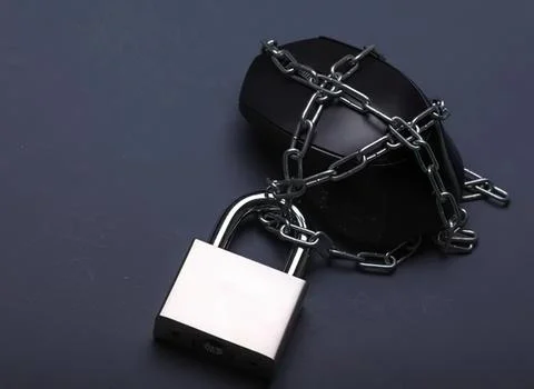 Black computer mouse wrapped in chains with padlock Stock Photos
