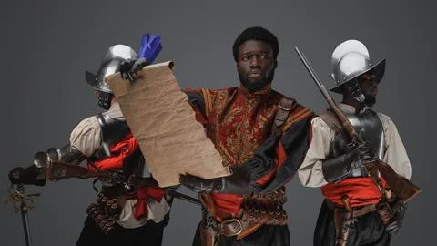 Black conquistador with map with two guards on his sides 写真素材