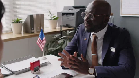 Black Consular Officer Explaining Reasons for Rejecting US Visa Applications Stock Footage 289788112