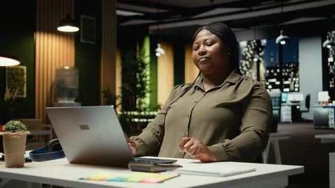 Black consultant focusing on a complex problem in a dark office at midnight Stock Photos