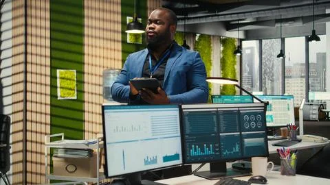 Black consultant leverages analytics and report writing for forecast results Stock Photos