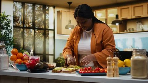 Black content creator creating food recipe with fresh avocado on toast Stock Photos
