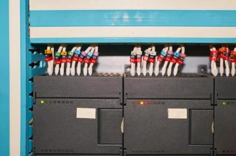 Black controller with connected colored numbered wires. Stock Photos