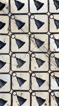 Black Copper Bells Pattern. Metallic Fence. Rustic Background. Grunge Wallpap Foto stock