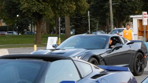 Black Corvette Hardtop With Driver Arriving At Exotic Car Stock Footage 89516791